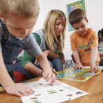Nursery nurse playing with children